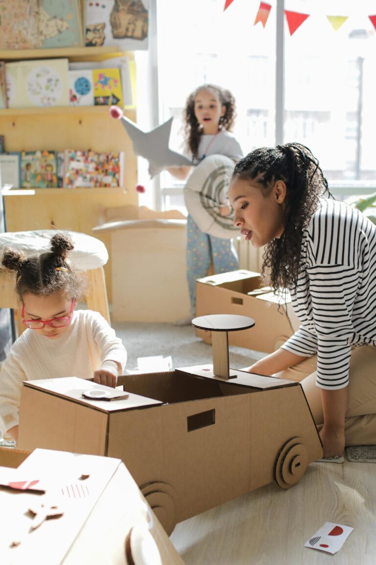 Children and adult engaging in creative play with cardboard toys indoors, fostering imagination.